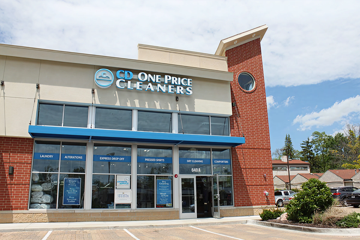 Exterior view of a CD One Price Cleaners retail location, displaying the storefront and building of one of the brand's service-based retail sites.