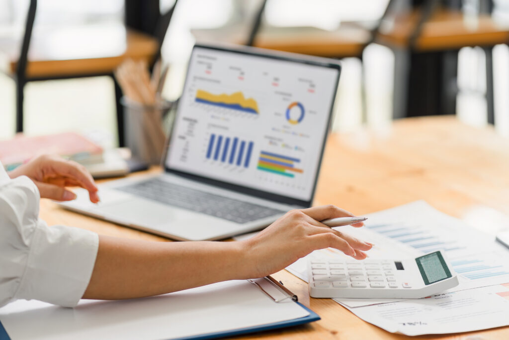 Analyzing Financial Data on Laptop with Calculations and Charts