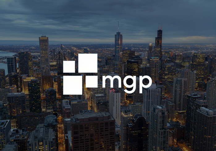 MGP logo over an aerial nighttime view of the Chicago skyline